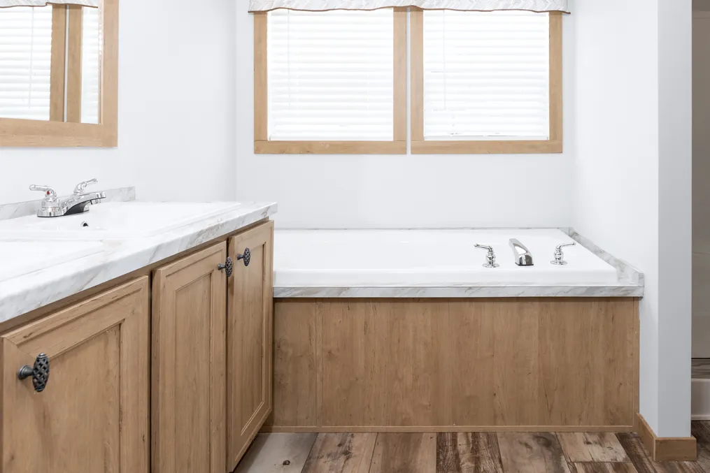 The THE BEXAR Primary Bathroom. This Manufactured Mobile Home features 3 bedrooms and 2 baths.