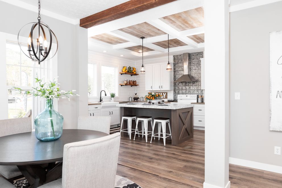 The 1440 CAROLINA 4BR BELLE Dining Area. This Manufactured Mobile Home features 4 bedrooms and 2 baths.