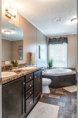 The 5604 ENTERPRISE 4 6428 Master Bathroom. This Manufactured Mobile Home features 3 bedrooms and 2 baths.