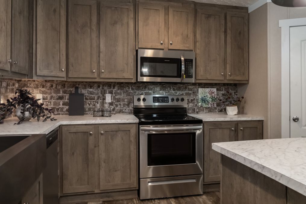 The ELITE COMMANDER 32X76 4 BR Kitchen. This Manufactured Mobile Home features 4 bedrooms and 2 baths.