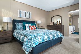 The FARMHOUSE FLEX Primary Bedroom. This Manufactured Mobile Home features 3 bedrooms and 2.5 baths.