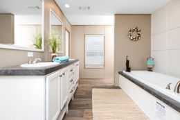 The FARMHOUSE FLEX Primary Bathroom. This Manufactured Mobile Home features 3 bedrooms and 2.5 baths.