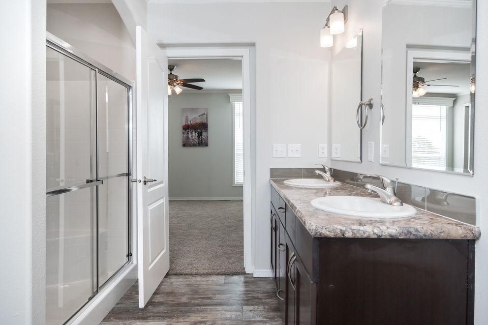 The ENCHANTMENT 3070A Primary Bathroom. This Manufactured Mobile Home features 3 bedrooms and 2 baths.