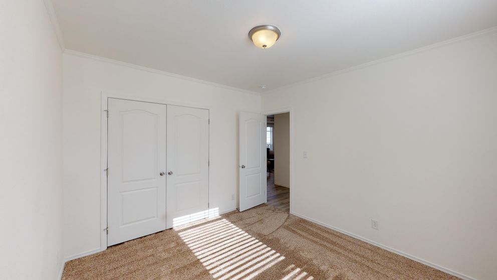 The SUM3068A Bedroom. This Manufactured Mobile Home features 3 bedrooms and 2 baths.