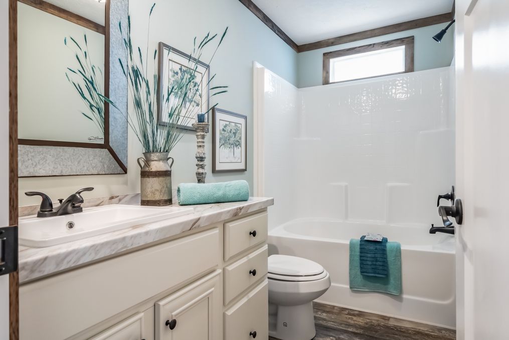 The THE EMMA JEAN Guest Bathroom. This Manufactured Mobile Home features 4 bedrooms and 3 baths.