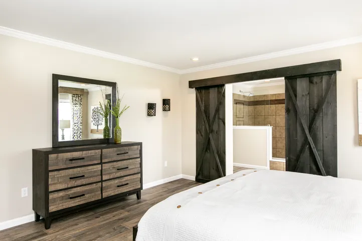The FREEDOM FARM HOUSE  32X60 Primary Bedroom. This Manufactured Mobile Home features 3 bedrooms and 2 baths.