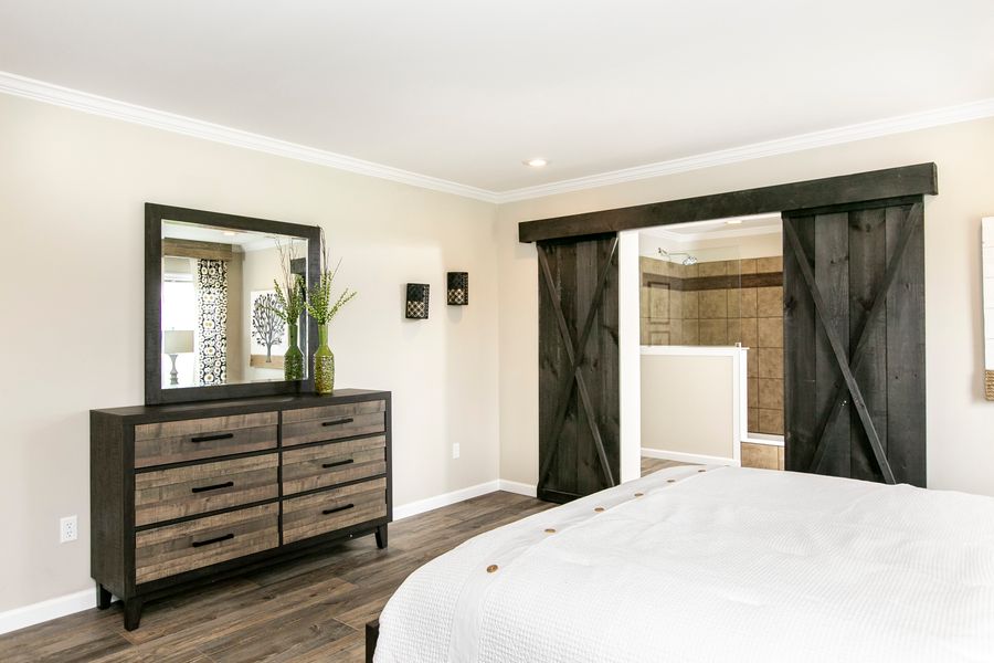 The FREEDOM FARM HOUSE  32X60 Primary Bedroom. This Manufactured Mobile Home features 3 bedrooms and 2 baths.