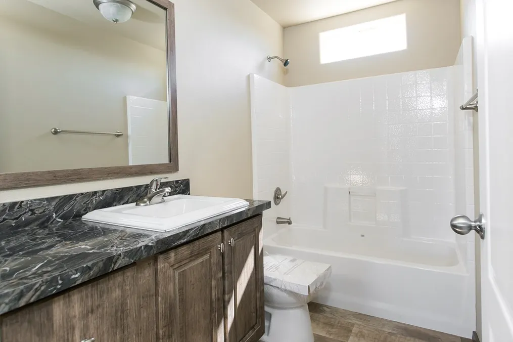 The 2022 COLUMBIA RIVER Guest Bathroom. This Manufactured Mobile Home features 3 bedrooms and 2 baths.