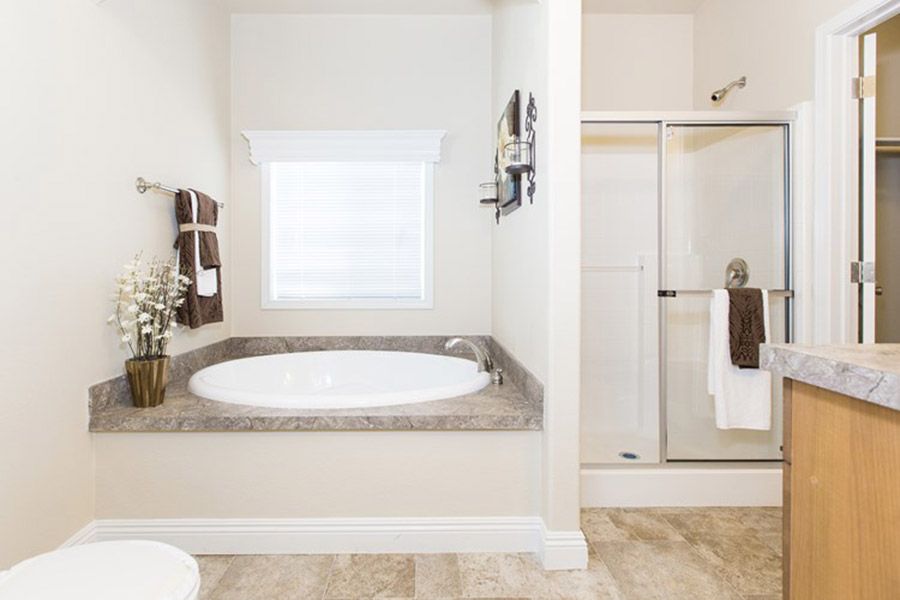 The K1676H Primary Bathroom. This Manufactured Mobile Home features 3 bedrooms and 2 baths.