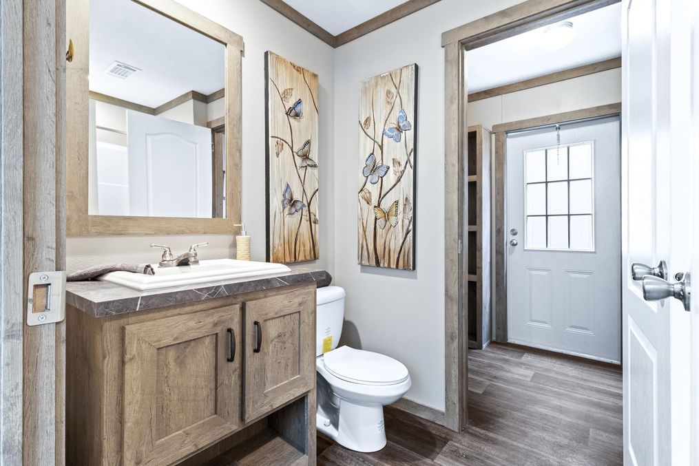 The COUNTRY COTTAGE Guest Bathroom. This Manufactured Mobile Home features 3 bedrooms and 2 baths.