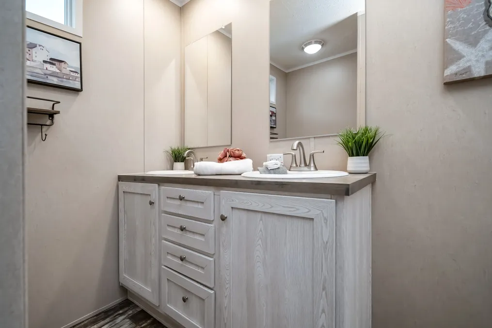 The ULTRO PRO HERCULES Guest Bathroom. This Manufactured Mobile Home features 3 bedrooms and 2 baths.