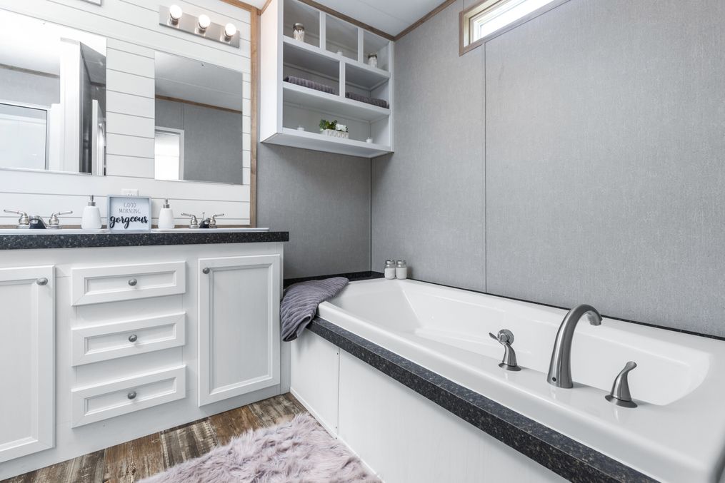 The THE ANNIVERSARY FARMHOUSE Master Bathroom. This Manufactured Mobile Home features 3 bedrooms and 2 baths.