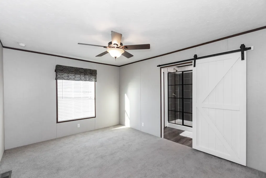 The THE REFLECTIONS Primary Bedroom. This Manufactured Mobile Home features 3 bedrooms and 2 baths.