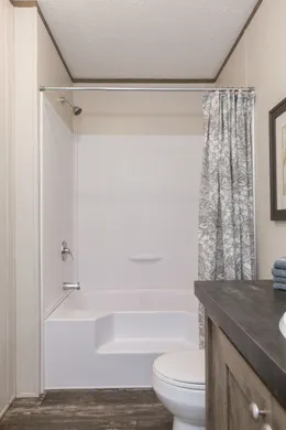 The THE BREEZE Guest Bathroom. This Manufactured Mobile Home features 3 bedrooms and 2 baths.