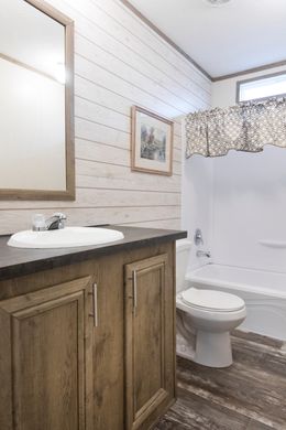 The THE SOUTHERN FARMHOUSE Guest Bathroom. This Manufactured Mobile Home features 3 bedrooms and 2 baths.