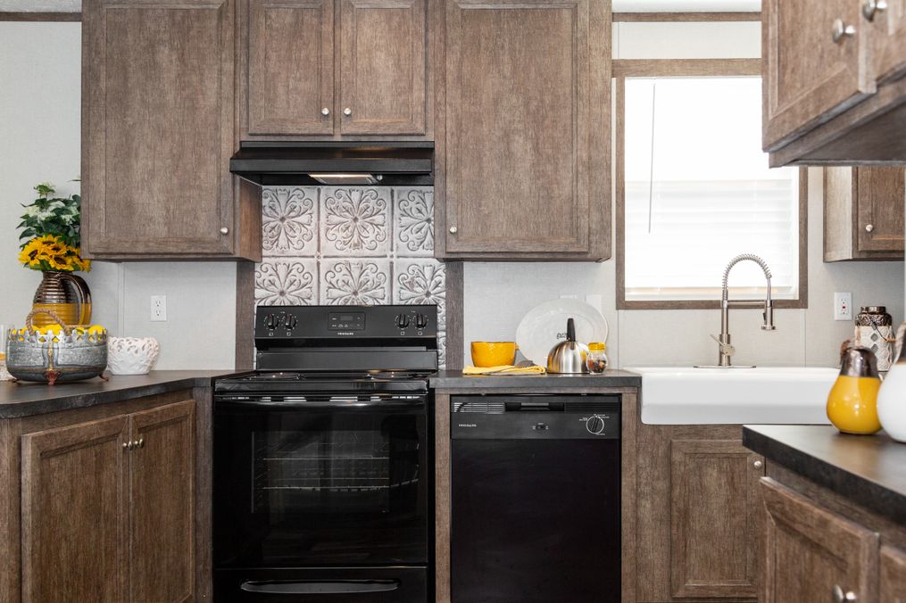 The THE ANNIVERSARY 76 Kitchen. This Manufactured Mobile Home features 3 bedrooms and 2 baths.