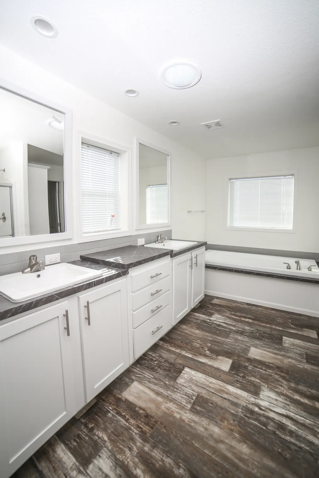 The EBONY Primary Bathroom. This Manufactured Mobile Home features 4 bedrooms and 2 baths.