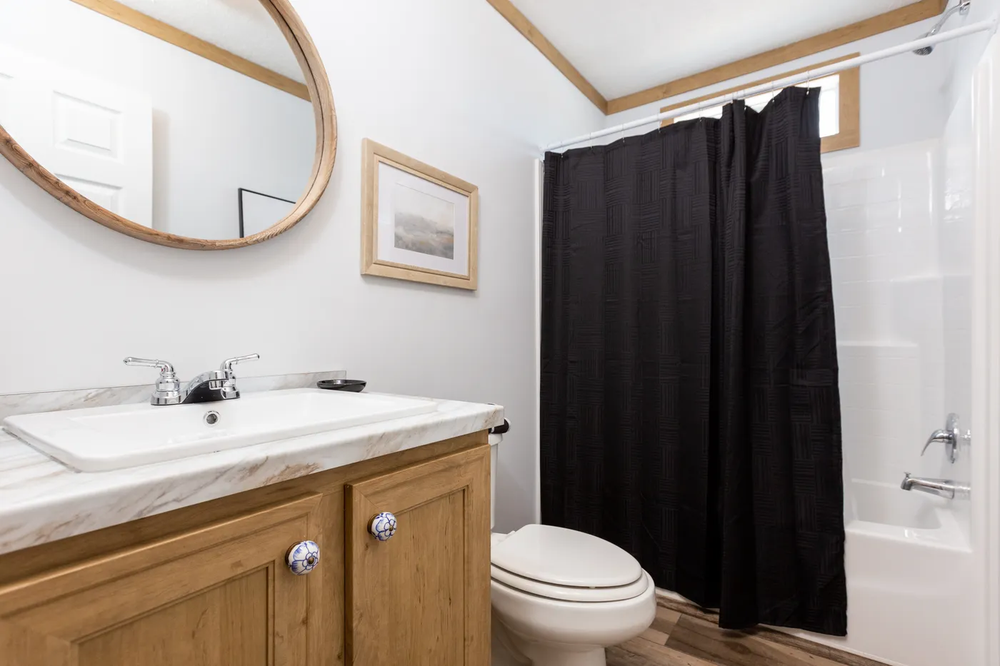 The THE KIMMEL Guest Bathroom. This Manufactured Mobile Home features 3 bedrooms and 2 baths.