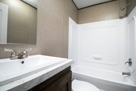 The ANNIVERSARY 16763S Guest Bathroom. This Manufactured Mobile Home features 3 bedrooms and 2 baths.
