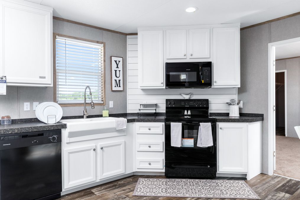 The THE ANNIVERSARY FARMHOUSE Kitchen. This Manufactured Mobile Home features 3 bedrooms and 2 baths.