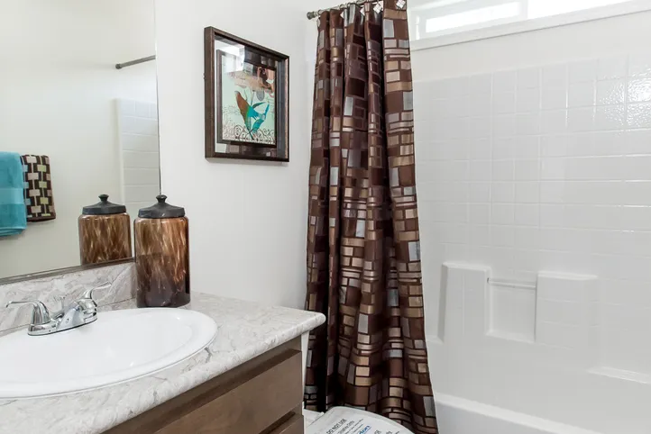 The FAIRPOINT 24463A Guest Bathroom. This Manufactured Mobile Home features 3 bedrooms and 2 baths.