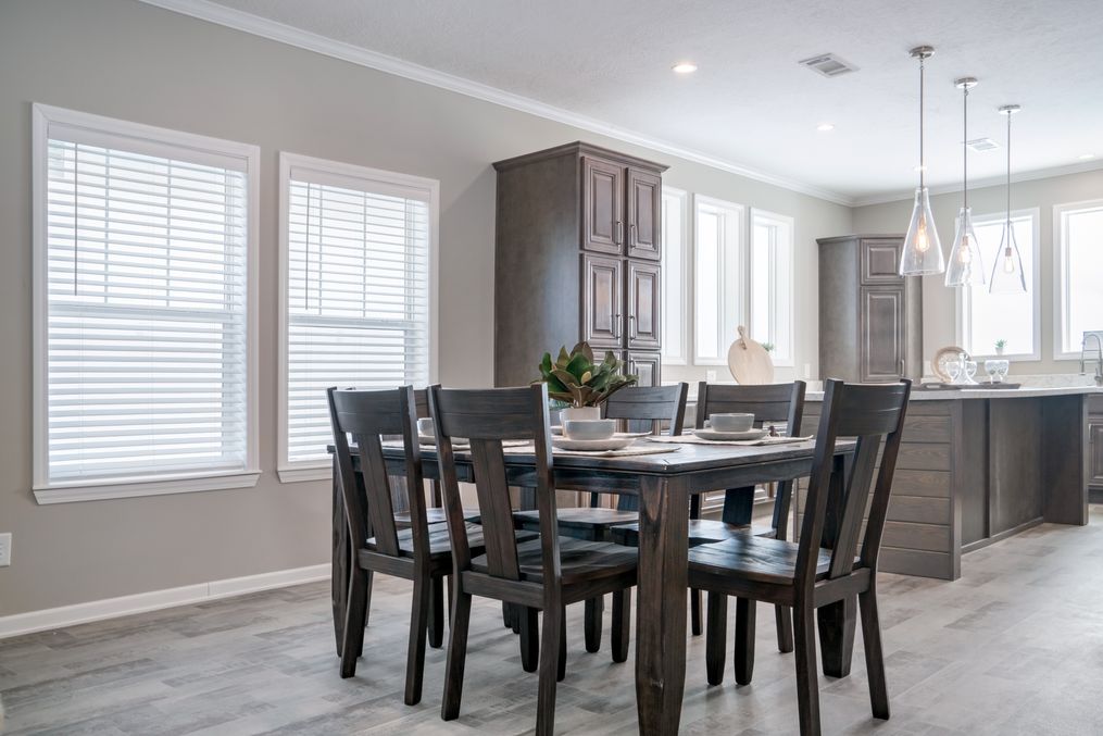 The THE HUXTON Dining Area. This Manufactured Mobile Home features 4 bedrooms and 3 baths.