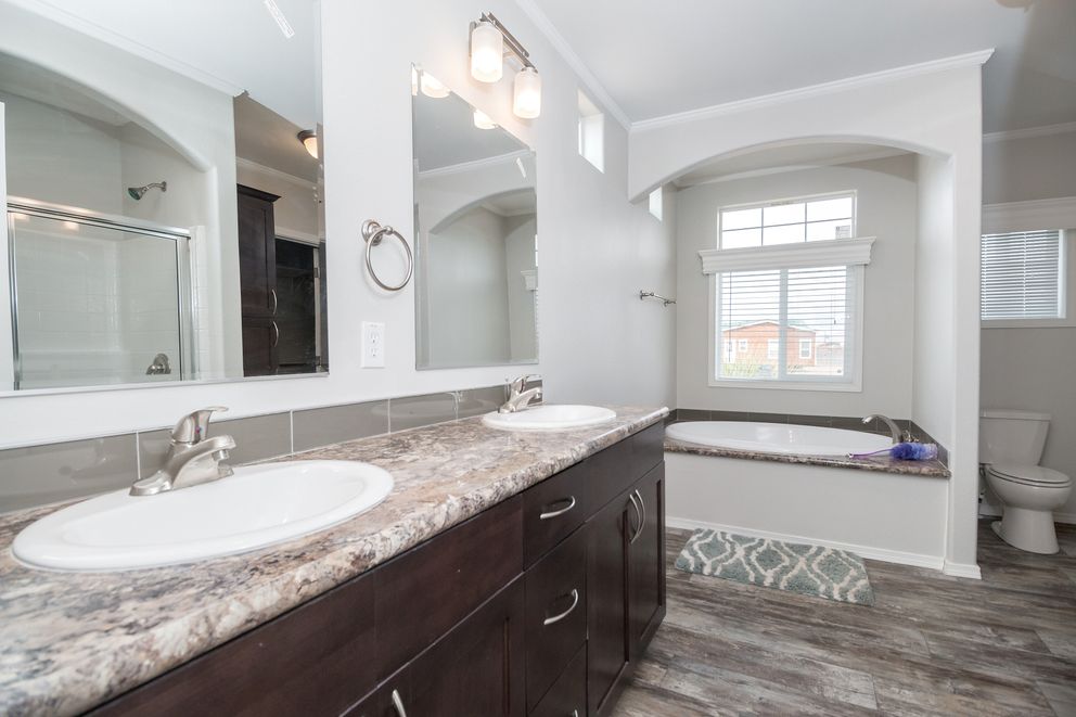 The ENCHANTMENT 3070A Primary Bathroom. This Manufactured Mobile Home features 3 bedrooms and 2 baths.