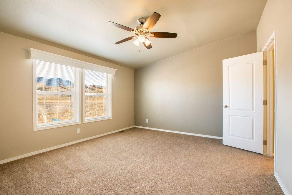 The THE WAVE Primary Bedroom. This Manufactured Mobile Home features 4 bedrooms and 2 baths.