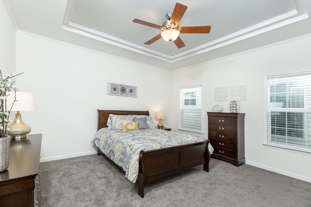 The 1714 HERITAGE Primary Bedroom. This Manufactured Mobile Home features 3 bedrooms and 2 baths.