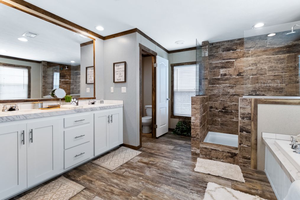 The THE MAVERICK Primary Bathroom. This Manufactured Mobile Home features 4 bedrooms and 2 baths.