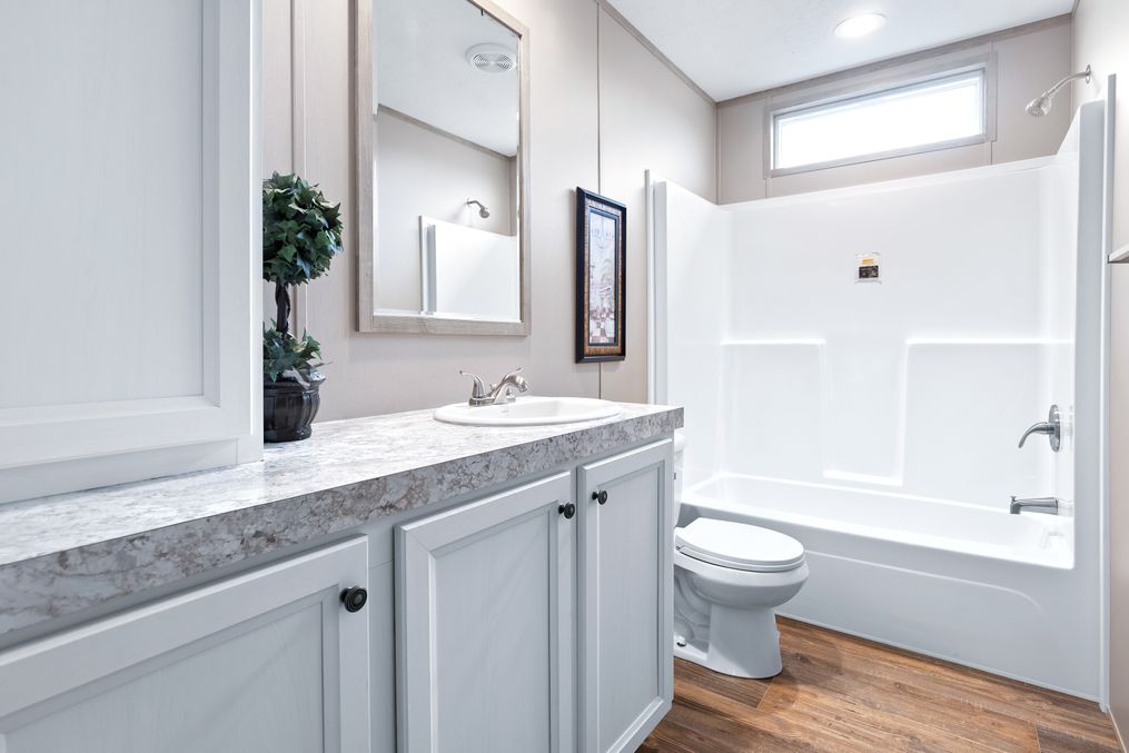 The BIG TICKET Guest Bathroom. This Manufactured Mobile Home features 4 bedrooms and 2 baths.