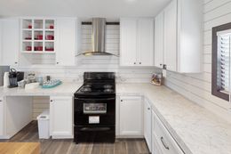 The BREEZE FARMHOUSE 72 Kitchen. This Manufactured Mobile Home features 4 bedrooms and 2 baths.