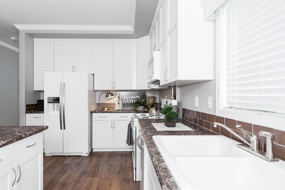 The ENCHANTMENT 3070A Kitchen. This Manufactured Mobile Home features 3 bedrooms and 2 baths.