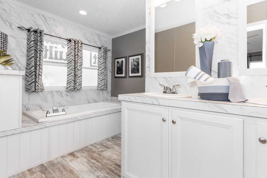 The THE CASCADE Primary Bathroom. This Manufactured Mobile Home features 4 bedrooms and 2 baths.
