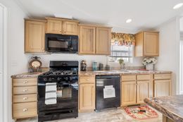 The FULTON 6028-2557D Kitchen. This Manufactured Mobile Home features 3 bedrooms and 2 baths.