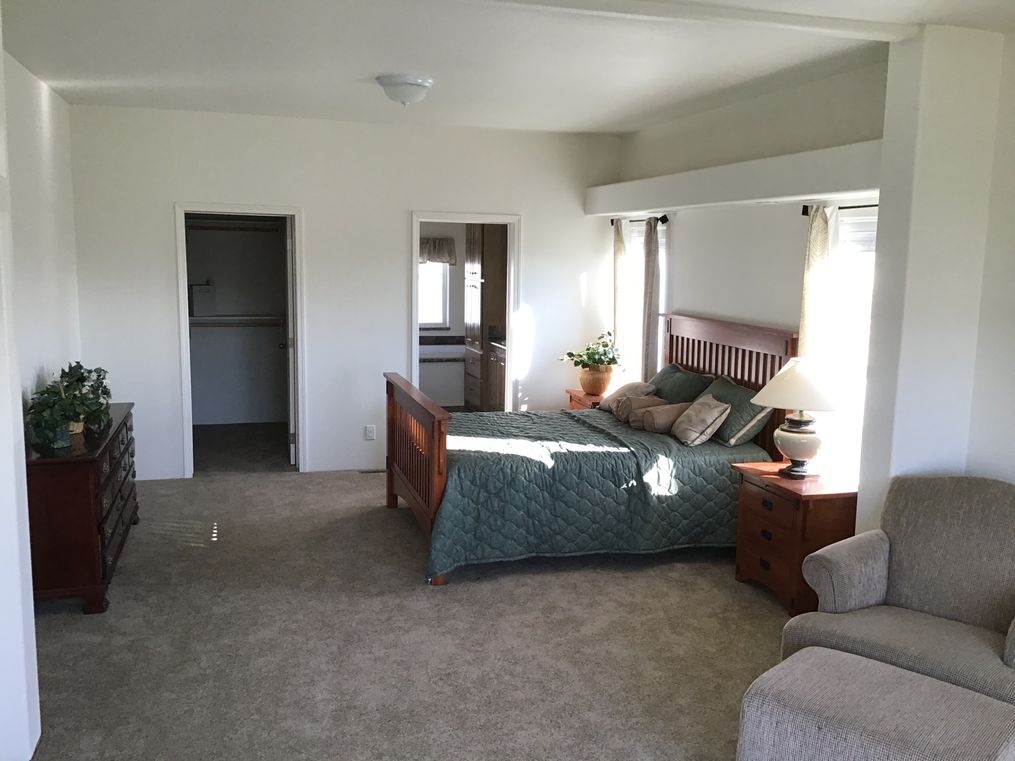 The 9593S         WASHINGTON Primary Bedroom. This Manufactured Mobile Home features 3 bedrooms and 3 baths.