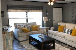 The THE MEADOWBROOK Living Room. This Manufactured Mobile Home features 4 bedrooms and 2 baths.