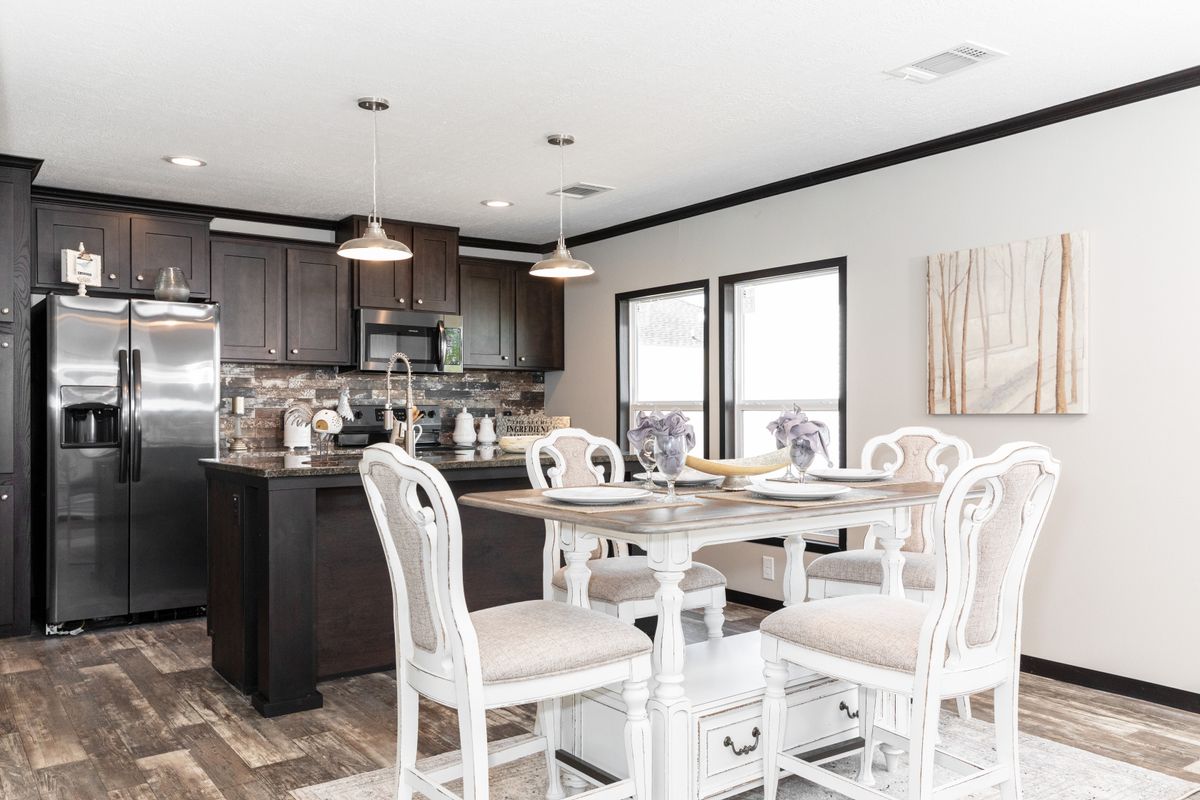 The THE FRANKLIN XL Dining Area. This Manufactured Mobile Home features 4 bedrooms and 2 baths.