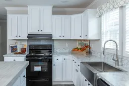 The THE FREEDOM BREEZE Kitchen. This Manufactured Mobile Home features 3 bedrooms and 2 baths.
