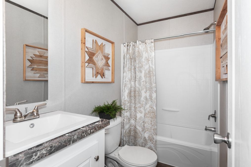 The PLATINUM ANNIVERSARY Guest Bathroom. This Manufactured Mobile Home features 3 bedrooms and 2 baths.
