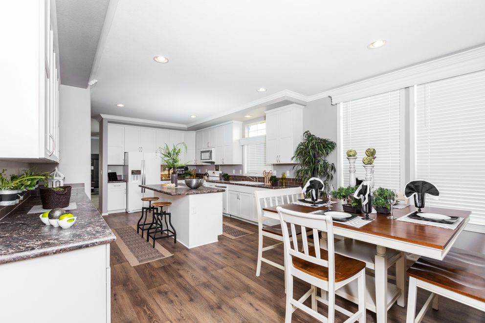 The ENCHANTMENT 3070A Dining Area. This Manufactured Mobile Home features 3 bedrooms and 2 baths.