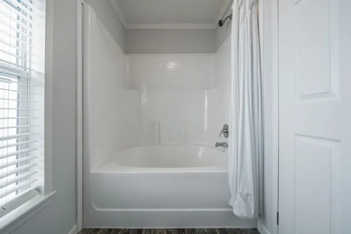 The THE LEAHY Guest Bathroom. This Manufactured Mobile Home features 4 bedrooms and 2 baths.