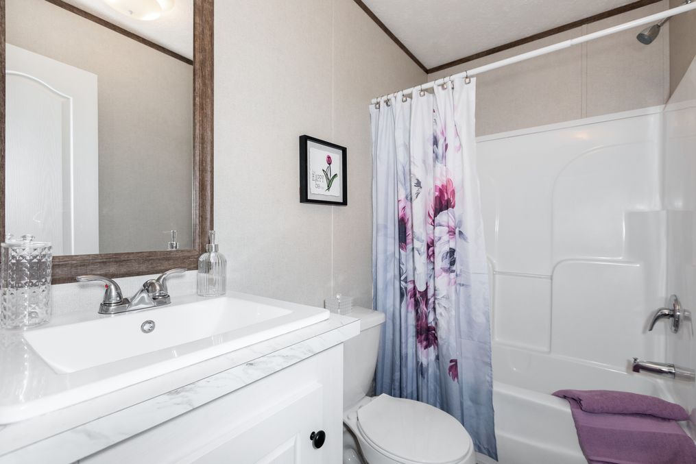 The BLAZER 76 P Guest Bathroom. This Manufactured Mobile Home features 3 bedrooms and 2 baths.