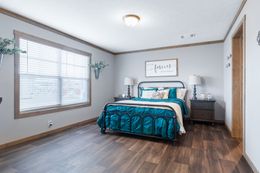 The FARMHOUSE 3 Primary Bedroom. This Manufactured Mobile Home features 3 bedrooms and 2 baths.