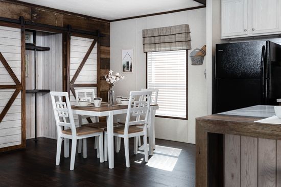 The THE STOCKTON Dining Room. This Manufactured Mobile Home features 4 bedrooms and 3 baths.