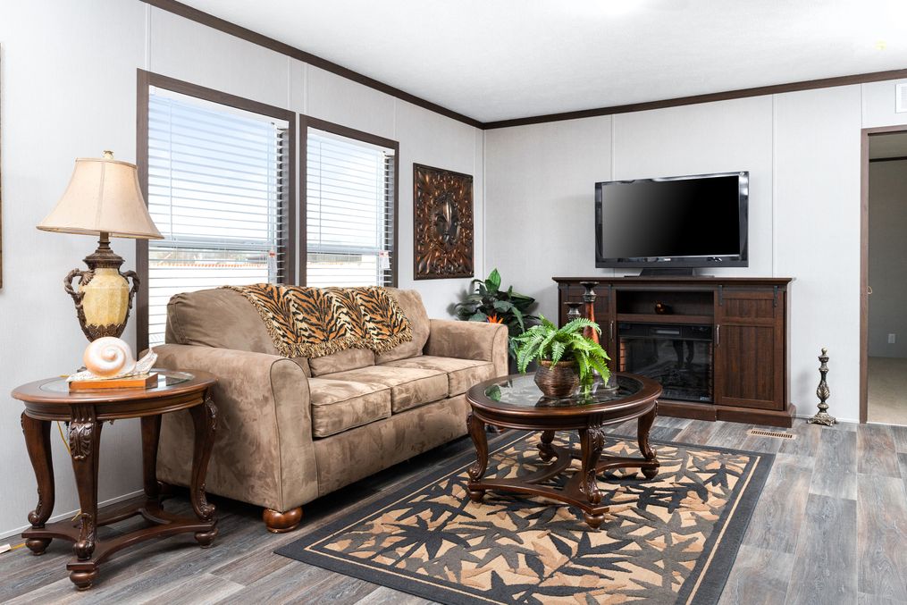 The THE CHOICE Living Room. This Manufactured Mobile Home features 4 bedrooms and 2 baths.