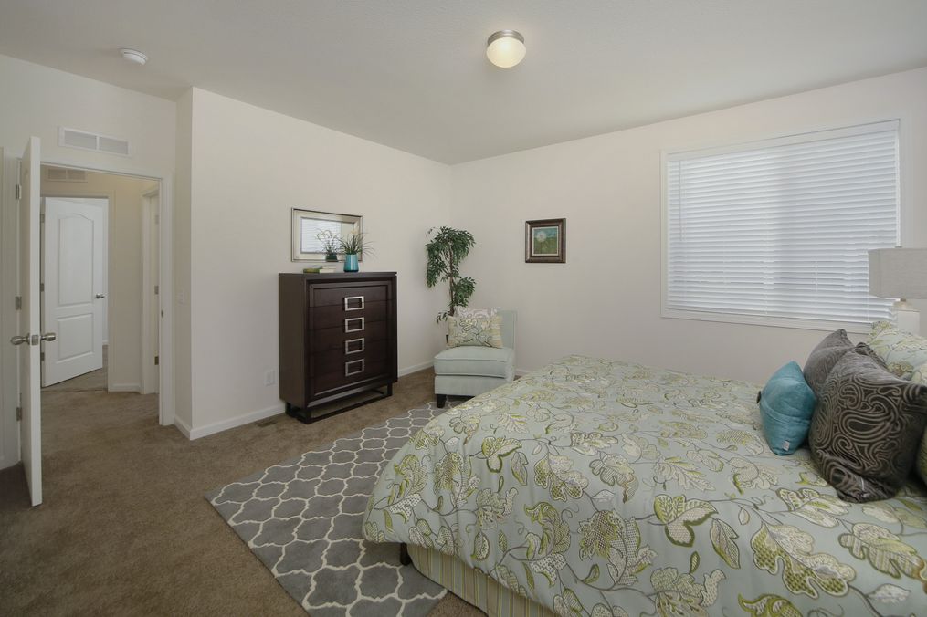 The MORRO BAY 27523-B Primary Bedroom. This Manufactured Mobile Home features 3 bedrooms and 2 baths.