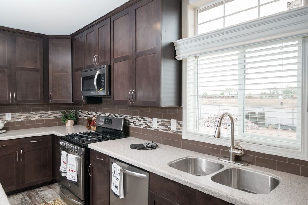 The ENCHANTMENT 3070A Kitchen. This Manufactured Mobile Home features 3 bedrooms and 2 baths.