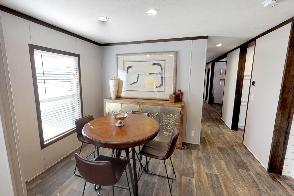 The BREEZE FARMHOUSE 72 Dining Area. This Manufactured Mobile Home features 4 bedrooms and 2 baths.
