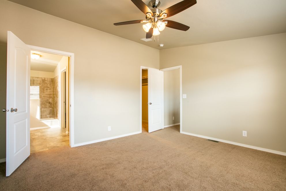 The THE WAVE Primary Bedroom. This Manufactured Mobile Home features 4 bedrooms and 2 baths.
